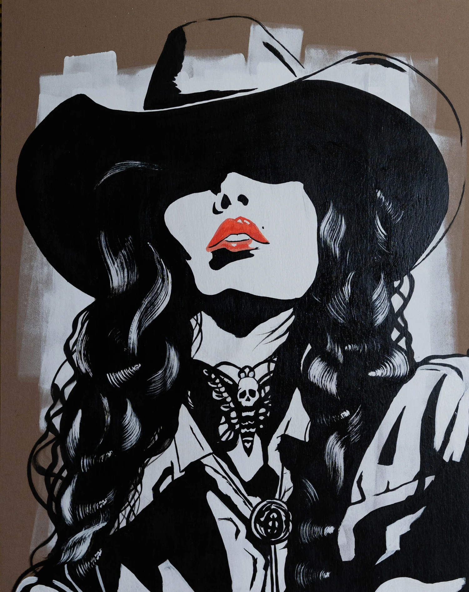 Don't Ask Twice: a cowgirl in a broad black hat, with red lips and a boldly patterned jacket.